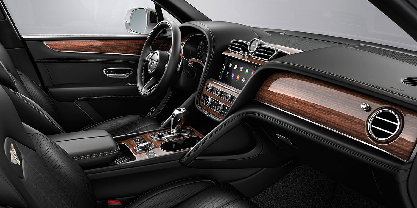 Bentley Shenzhen - Luohu Bentley Bentayga interior with a Crown Cut Walnut veneer, view from the passenger seat over looking the driver's seat.
